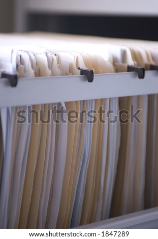 A file cabinet drawer is open and all the records can be seen