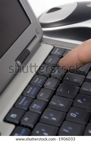 A person pressing the delete key on a laptop