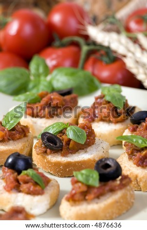 The perfect Italian appetizer, fresh bruschetta with basil and olives.