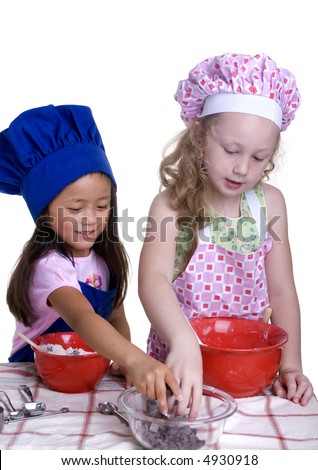 2 young girls having fun in the kitchen making a mess....I mean making something special..... Education, learning, cooking, childhood