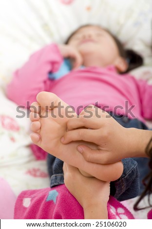 Two sisters playing on the bed, tickling feet.