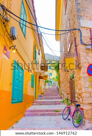 Narrow road with beautiful historic buildings in Nafplio town in Greece