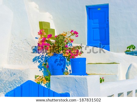 Detail from the backyard of an old traditional house with colorful plants in Oia the most beautiful village of Santorini island in Greece