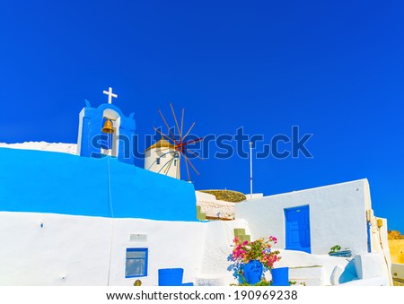Blue colored belltower from an old traditional church in Oia the most beautiful village of Santorini island in Greece