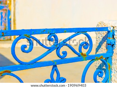 Detail from the iron made blue colored door of an old traditional house in Oia the most beautiful village of Santorini island in Greece