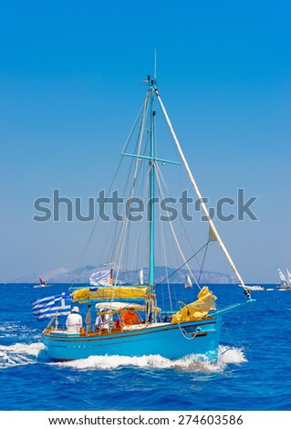 SPETSES, GREECE - JUN 22, 2014: Unidentified people on a Greek classic wooden sailing boat during a regatta in Spetses island in Greece on Jun 22, 2014