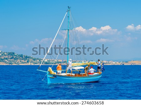 SPETSES, GREECE - JUN 22, 2014: Unidentified people on a Greek classic wooden sailing boat during a regatta in Spetses island in Greece on Jun 22, 2014