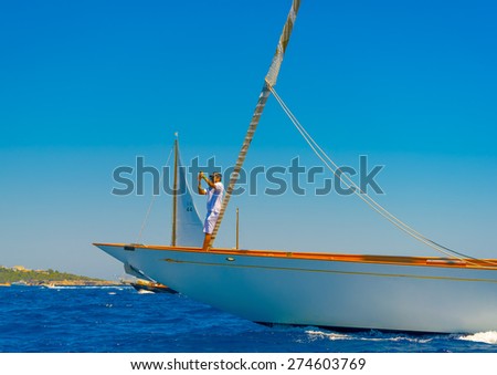SPETSES, GREECE - JUN 21, 2014: Unidentified people on a Classic wooden sailing boat during a regatta in Spetses island in Greece on Jun 21, 2014