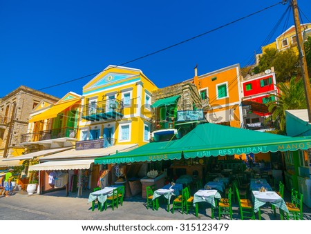 SYMI, GREECE - AUGUST 25, 2014: A famous fish tavern on the pictorial harbor of Symi on August 25, 2014 on Symi island, in Greece.