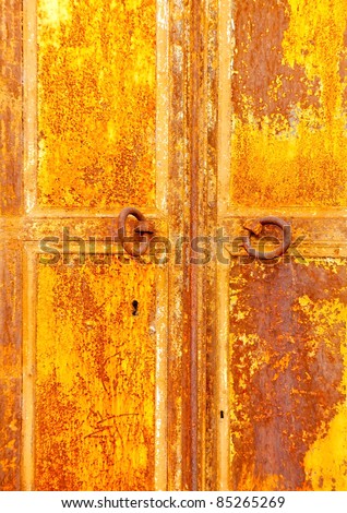 Ruined door from iron from an old store in Kavala town in Greece
