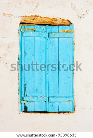 A wooden blue colored window of a Beautiful old traditional house in Chora the capital of Amorgos island in Greece