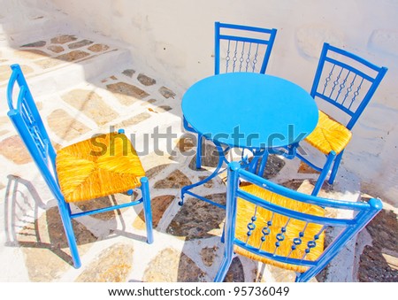 Old traditional beautiful iron made round shaped small coffee tables and chairs out of a cafe in Chora the capital of Amorgos island in Greece