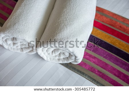 White towel on the bed in relaxation bedroom of luxury boutique hotel