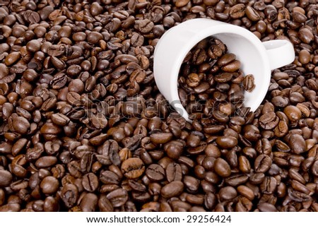 Cup of coffee filled up with beans
