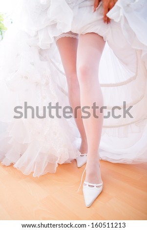 Bride fitting shoes on her wedding day