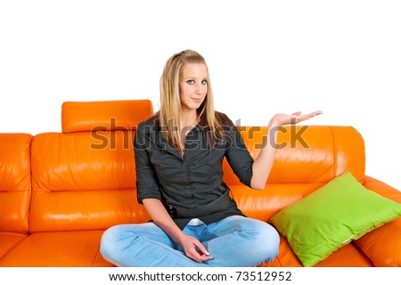 attractive young woman with hands on waist sitting on a sofa