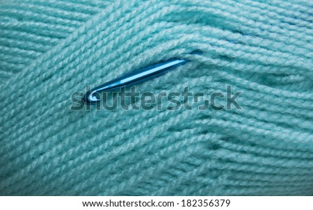 Crochet hook and knitting yarn - closeup