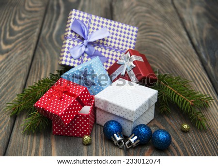 christmas baubles with heap of gift boxes on a wooden background