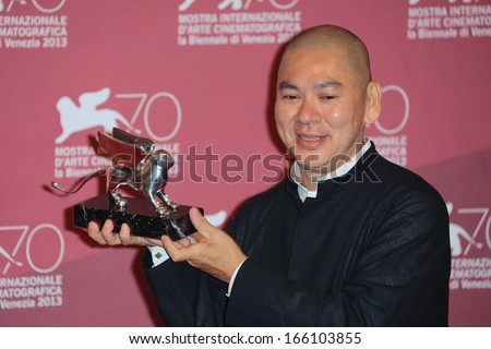 VENICE, ITALY - SEPTEMBER 07: Tsai Ming-liang poses with the Grand Jury Prize he received for his movie \'Jiaoyou\' during the 70th Venice Film Festival on September 07, 2013 in Venice, Italy