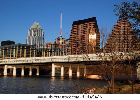 Austin, Texas downtown skyline at sunset, embraced by the beauty of Lady Bird Lake.