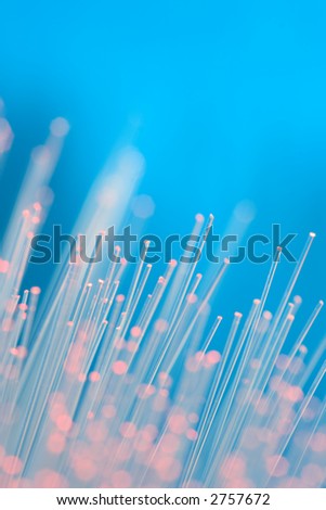 Optical fibers with pink light and blue background