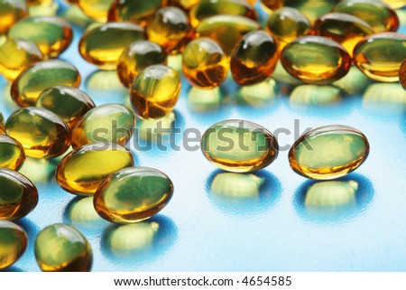 Omega-3 fish oil capsules on blue surface
