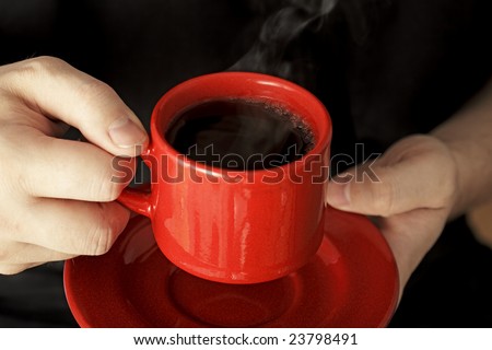 Red cup of steaming hot black coffee