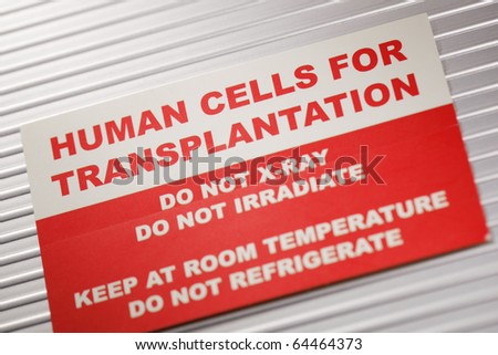 Human Cells for Transplantation information sticker. Short depth-of-field.