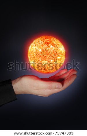 A Glowing floaing above a hand. Sun images provided by NASA.