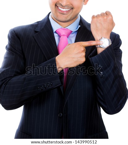 Time is money. A close-up portrait of a businessman pointing at his watch reminding that it is time to get back to work, isolated on a white background