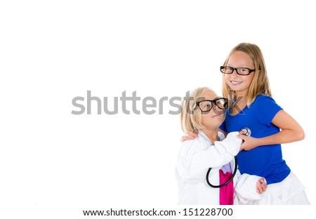 Closeup portrait of adorable girl child doctor listening to heart of another kid, isolated on white background with copy space