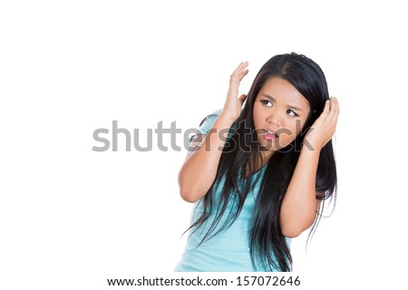 A close-up portrait of a scared , terrified lonely young woman raising hands up scared of something, isolated on a white background with copy space.