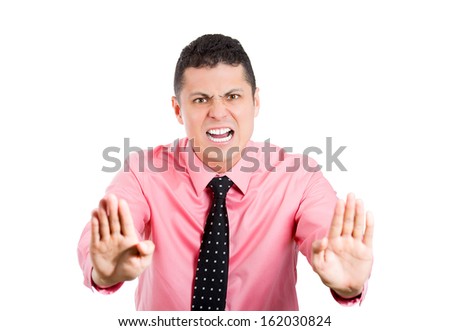 Closeup portrait of young angry pissed off, upset rude serious man with black tie gesturing stop with palms hands and open mouth, isolate on white background. Negative human emotion facial expressions