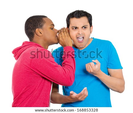 Closeup portrait of guy whispering into man\'s ear, telling something secret, disturbing. Shocked, surprised, disgusted, wide open mouth response. Negative human emotions, facial expression, feelings
