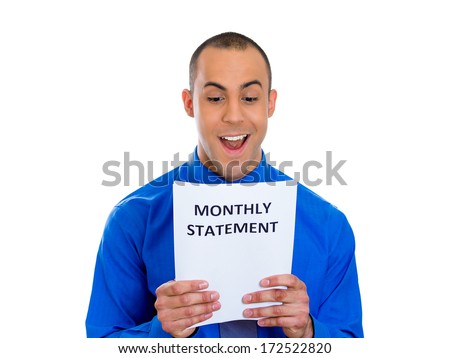 Closeup portrait of happy excited young man looking at monthly statement glad to pay off bills, isolated on white background. Positive emotion facial expression feelings. Financial success, good news