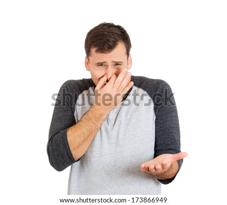 Closeup portrait of young man, disgust on face, pinches his nose, something stinks very bad smell, situation, asking is it you, isolated on white background. Negative emotion facial expression feeling