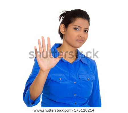 Closeup portrait of young annoyed woman with bad attitude giving talk to the hand gesture with palm outward, isolated on white background. Negative emotion facial expression feelings, body language