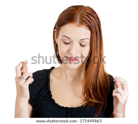 Closeup portrait of a young pretty happy woman crossing fingers wishing and praying for miracle, hoping for the best, isolated on white background. Positive emotions facial expression feelings