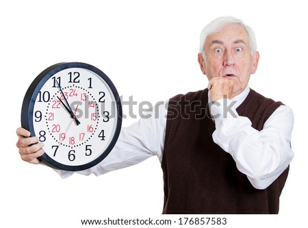 Closeup portrait of old business man, funny looking elderly guy, holding clock, stressed running out, pressured by lack of time, aging, late for meeting isolated on white background. Negative emotions
