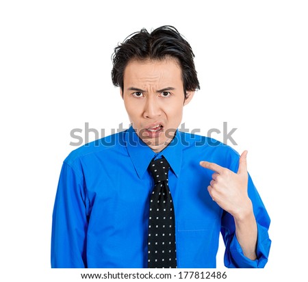 Closeup portrait of angry unhappy annoyed young man getting mad, asking question you talking to, mean me? Isolated on white background. Negative human emotions, facial expressions, reaction, attitude