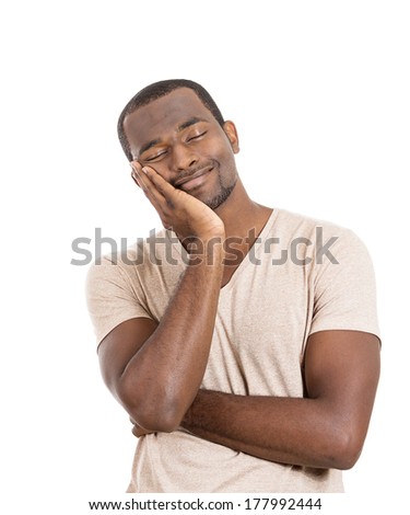 Closeup portrait of happy guy, young handsome man with closed eyes dreaming, remembering good times hand on chin, isolated on white background. Positive human emotions, facial expression, feelings