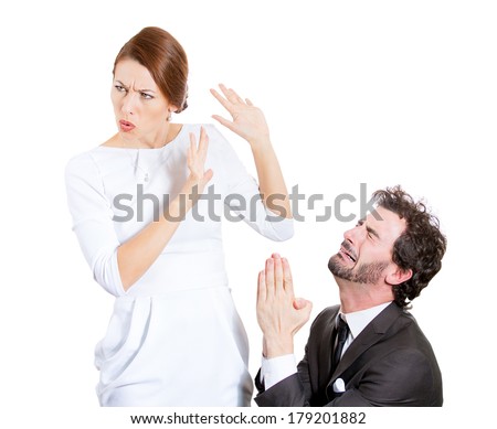 Closeup portrait of couple, man, woman. Sad husband on his knees asking, begging for forgiveness wife who is reluctant to accept apology, isolated on white background. Human emotions, face expressions