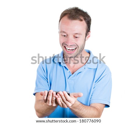 Closeup portrait of surprised, shocked happy young man, student excited  by what he sees on his cell phone, isolated on white background. Positive human emotions, facial expression, feelings, reaction
