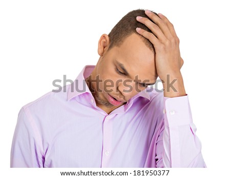 Closeup profile portrait of sad bothered stressed serious young man, hand on head, depressed about something or someone, isolated white background. Negative human emotion facial expression feeling
