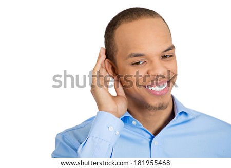 Closeup portrait of curious young, nosy, happy man hand to ear trying to secretly listen in on juicy gossip, conversation, news, and happy what he hears, privacy violation, isolated white background