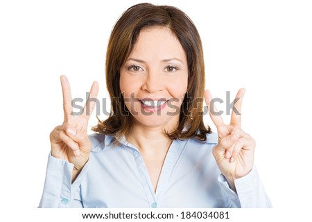 Closeup portrait, young, happy, smiling, confident, excited woman giving peace victory, two sign gesture, isolated white background. Positive human emotion facial expression feeling symbol, attitude