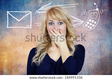 Closeup portrait, beautiful, blonde young woman shocked by number of missed messages on cell phone device, isolated background, mailbox, arrow, smart phone. Human facial expression emotion, feelings
