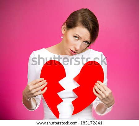 Closeup portrait young, troubled, sad, confused woman, holding broken heart in hands, about to cry, isolated magenta background. Negative human emotion, facial expression, feelings, attitude, reaction