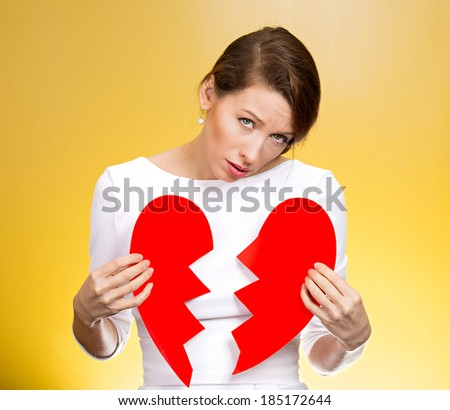 Closeup portrait young, troubled, sad, confused woman, holding broken heart in hands, about to cry, isolated background. Negative human emotions, facial expression, feelings, attitude, reaction