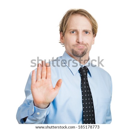 Closeup portrait, surprised helpless young man raising hand up to say no stop right there, isolated white background. Negative emotion facial expression feelings, signs symbols, body language